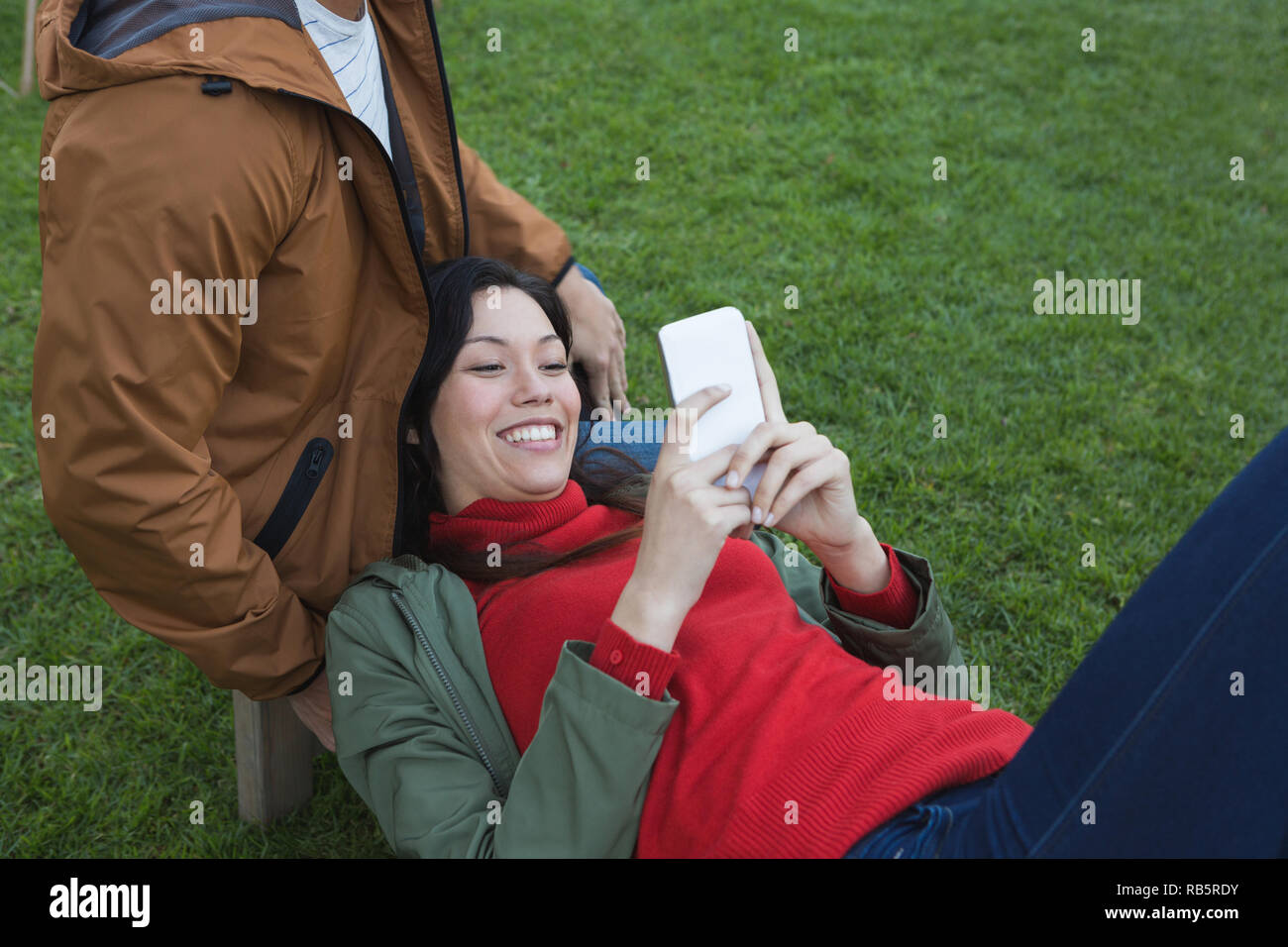 Woman using mobile phone with man Stock Photo