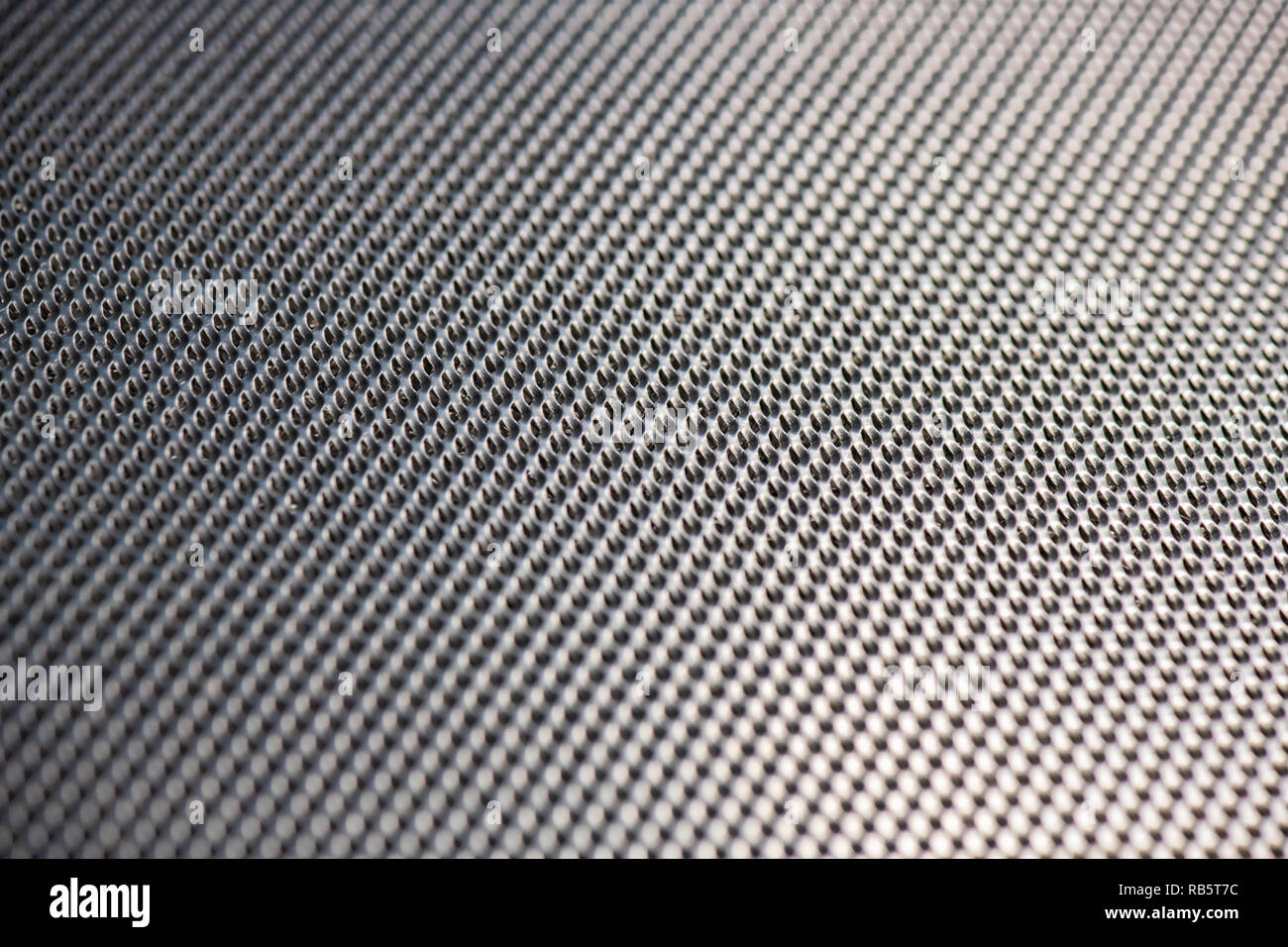 Silver Metallic Background with pattern in diagonal lines and blurred foreground and background. Stock Photo