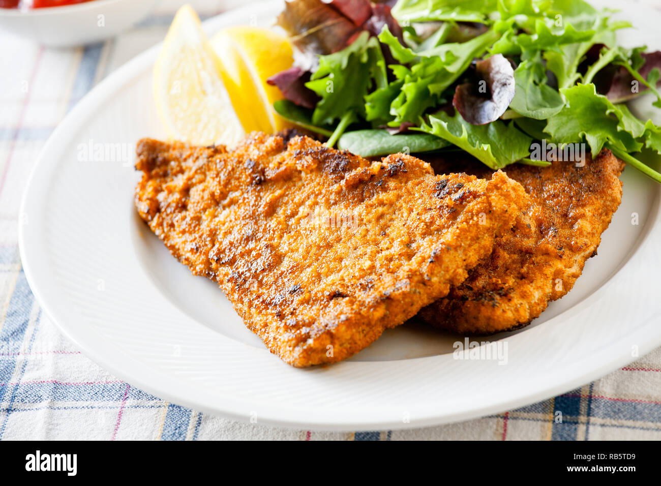 Homemade breaded pork schnitzel with some green salad Stock Photo Alamy