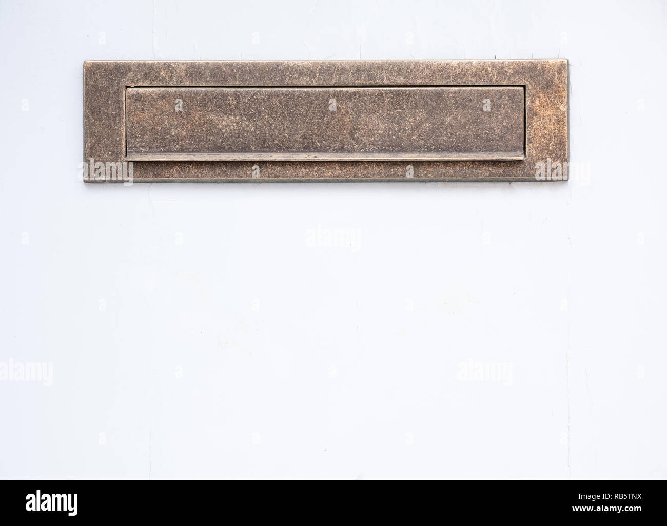 Old bronze mailbox. Brass vintage mail letter box on white color wall background. Closeup view with details Stock Photo