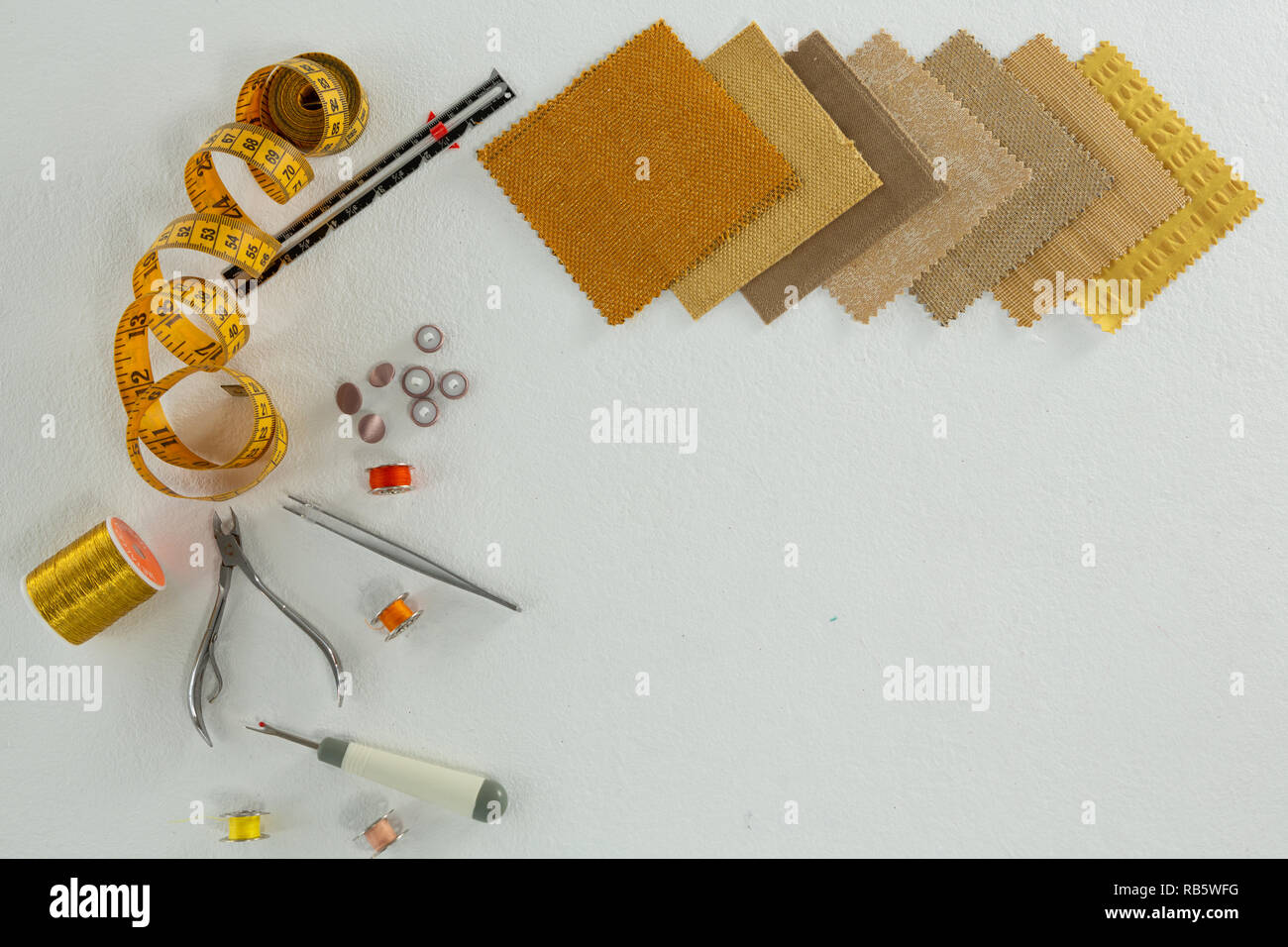 Thread rolls and various tools on white background Stock Photo - Alamy
