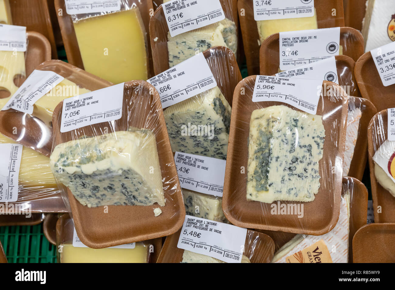 French cheese, shrinkwrapped, in refrigerated counter; France Stock