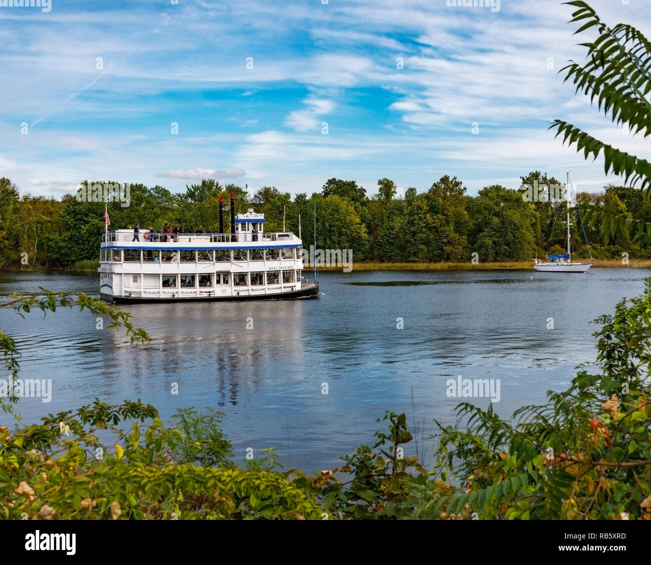 A relaxing sunny autumn afternoon riverboat ride along the Connecticut River. Deep River, Connecticut, USA. Along the Essex steam train railroad line. Stock Photo
