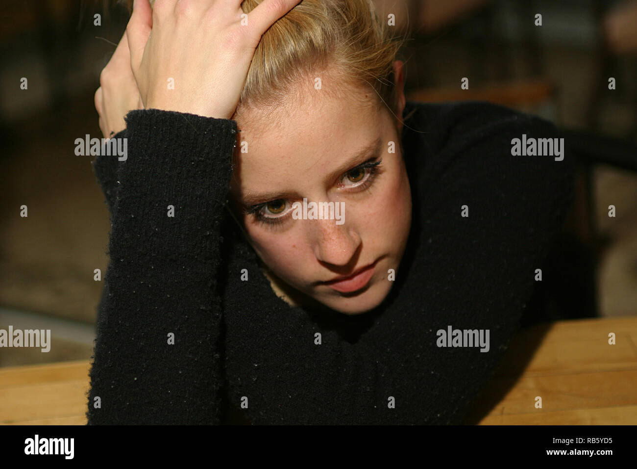 Really stressed out blonde girl having a bad day Stock Photo