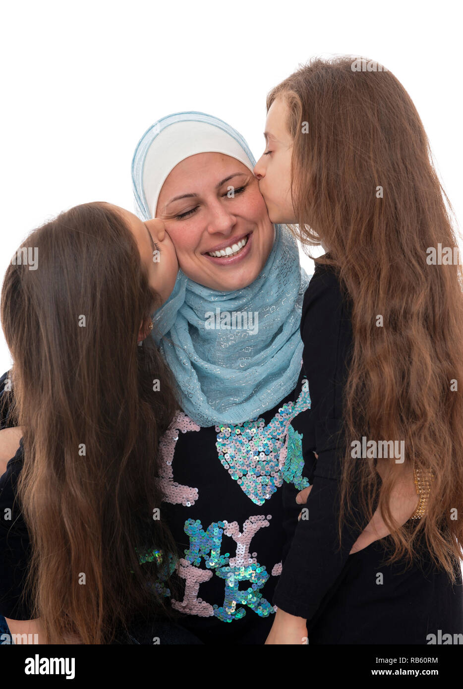 Young Beautiful Girls Kissing Their Happy Muslim Mother Celebrating Mother's Day Isolated on White Background Stock Photo