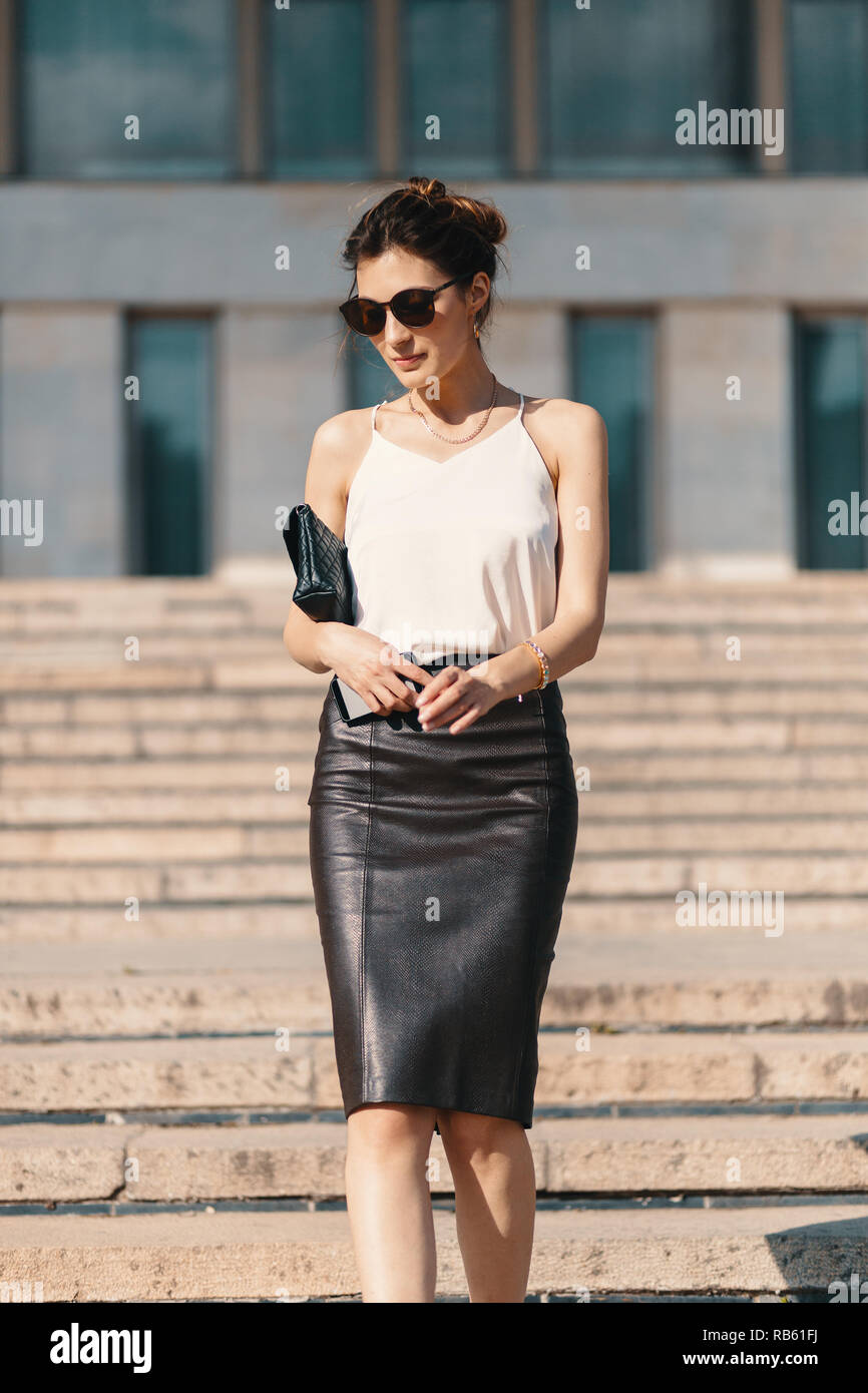 Fashionable Brunette Businesswoman In A Brown Leather Pencil Skirt And  Cream Silk Blouse Sunglasses Walking In The Street On Stairs Fashion  Spring Summer Photo Long Legs Stock Photo Picture and Royalty Free