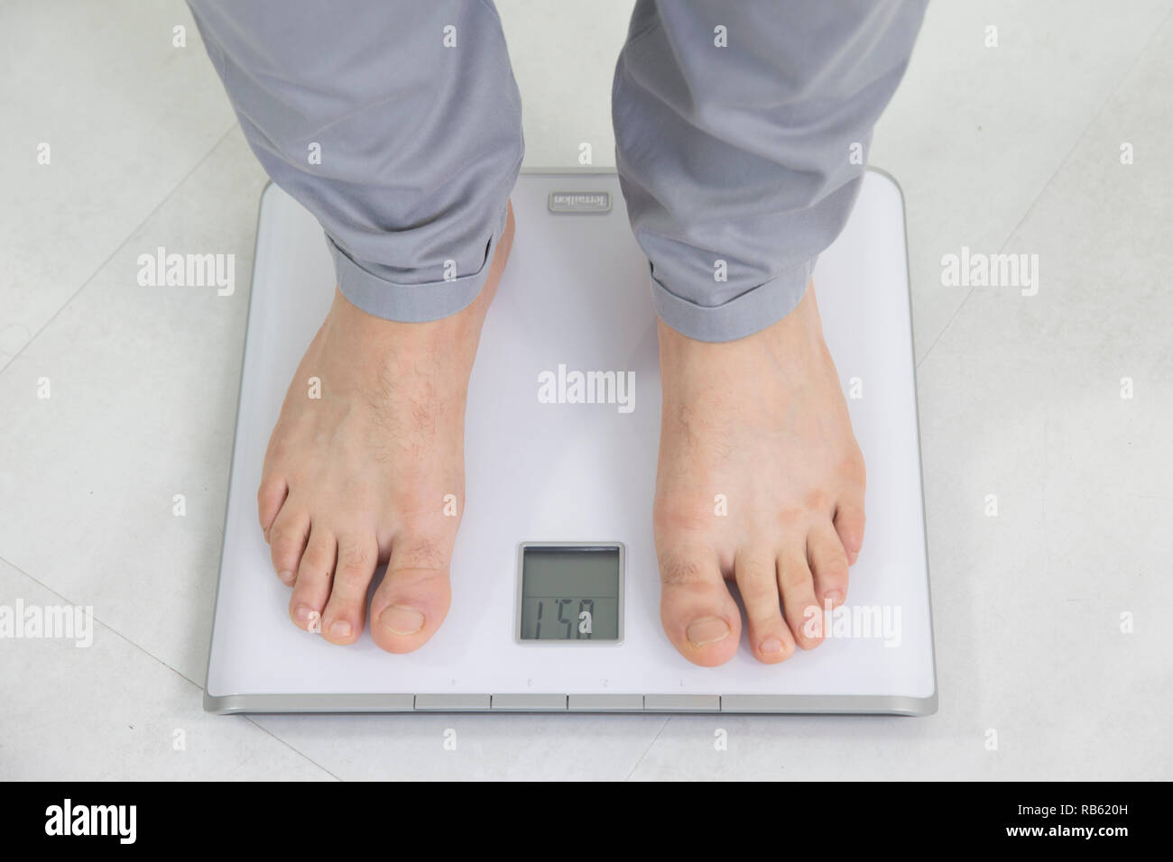 Man on a bathroom scale hi-res stock photography and images - Alamy