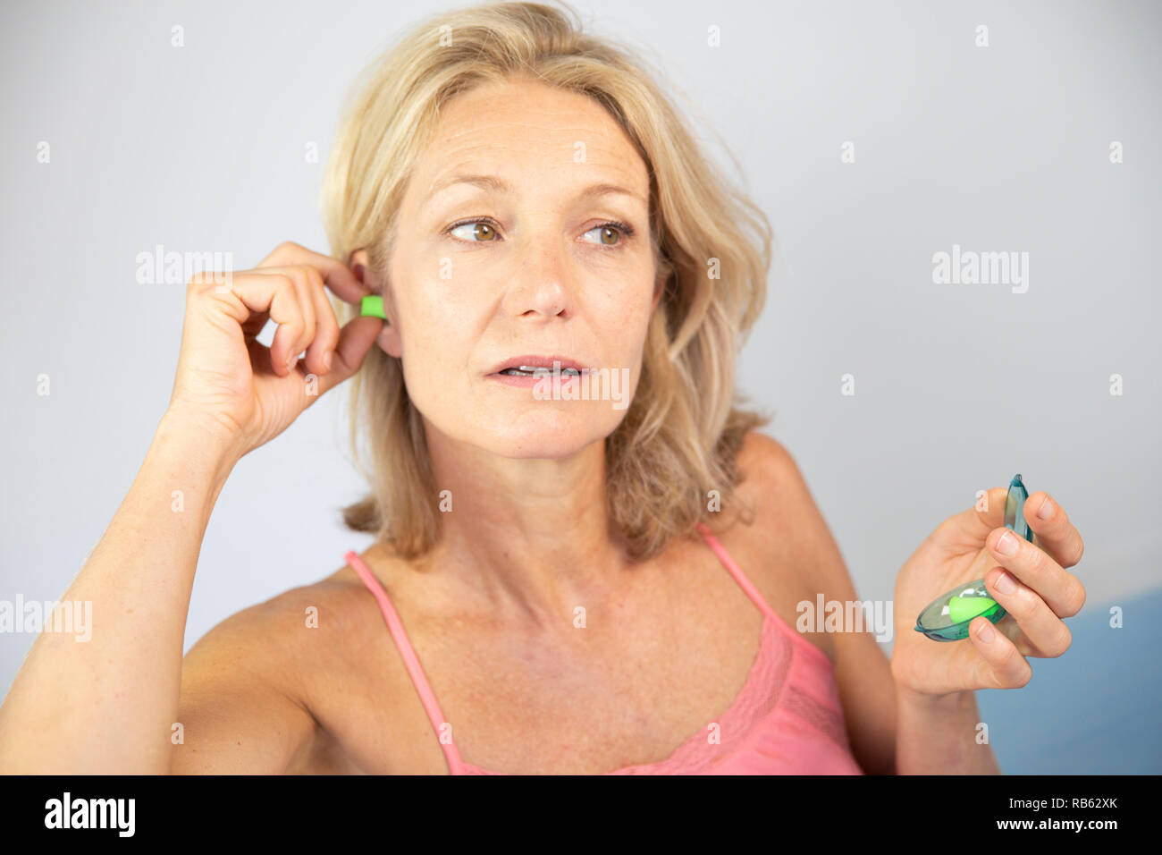 Woman using earplugs Stock Photo Alamy