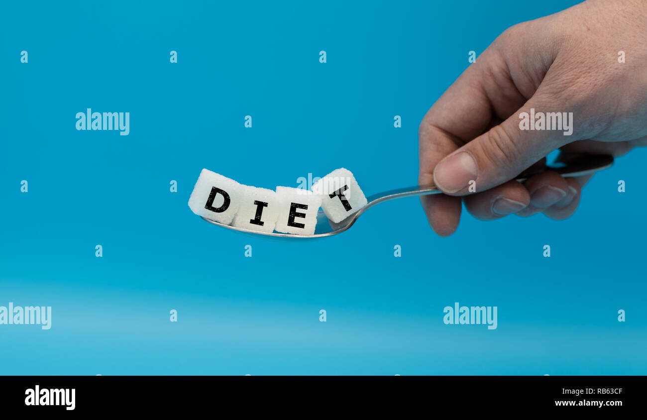 A spoon full of sugar cubes form the word "DIET" Stock Photo