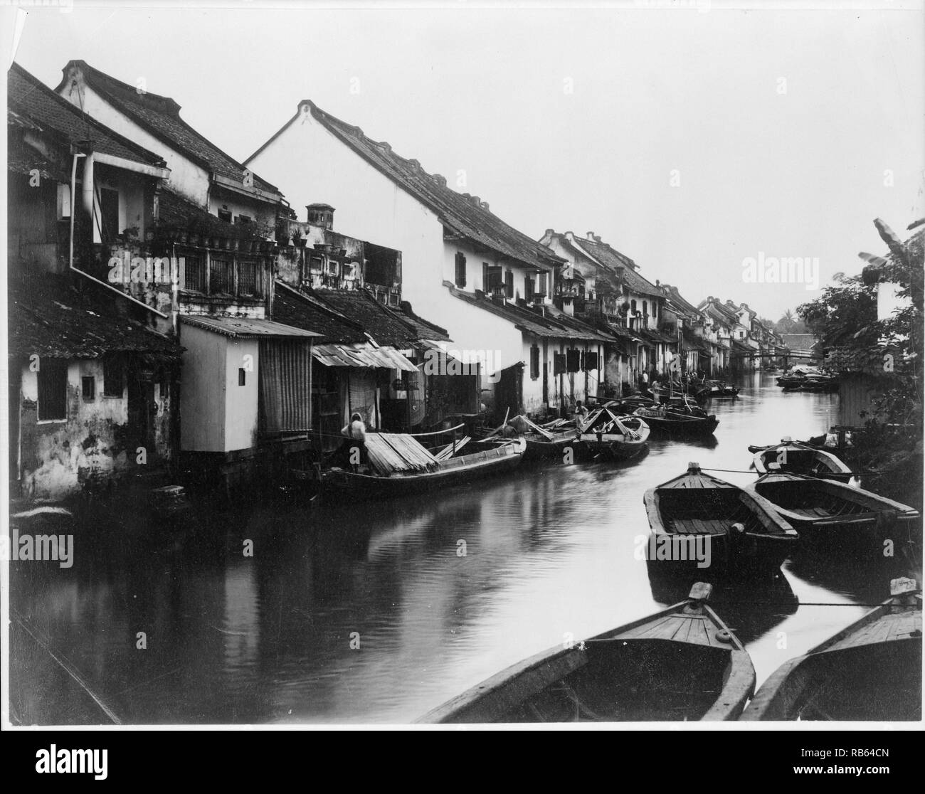 Photograph of small boats on a village canal in Indonesia. Dated 1900 Stock Photo
