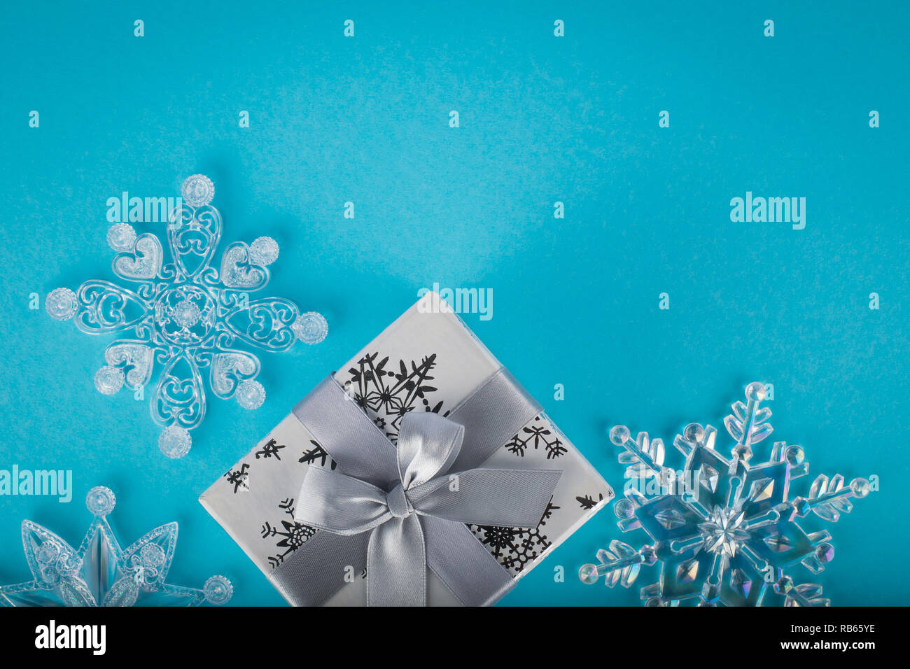 Christmas composition with gift box and decorative snowflakes Stock Photo