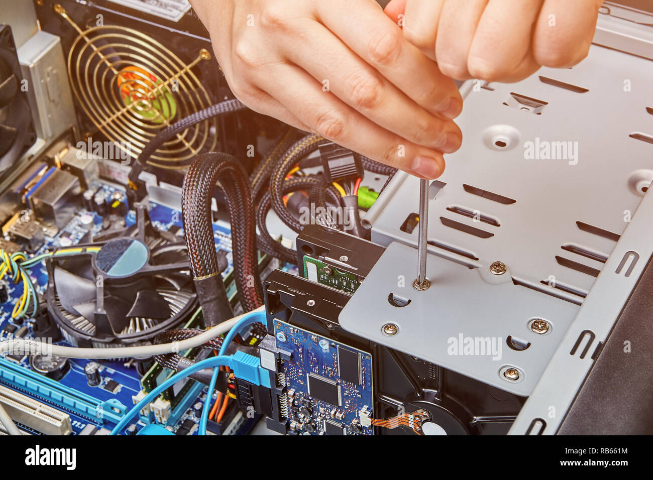 Hardware installation and upgrades of the computer system unit with help of  screwdriver Stock Photo - Alamy