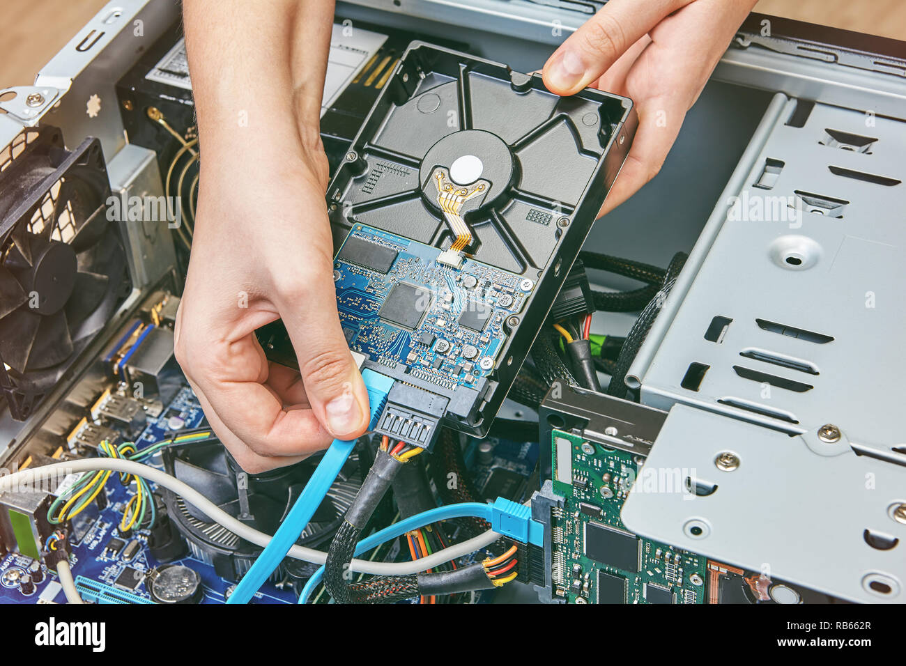 Plugging in SATA data cable to the hard disk drive of the personal computer  Stock Photo - Alamy