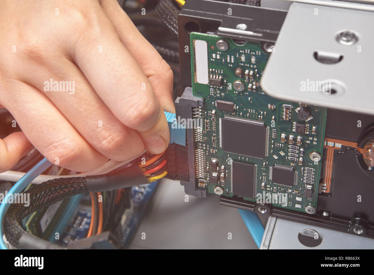 Connecting SATA cable to the motherboard of unassembled the personal  computer, close-up Stock Photo - Alamy