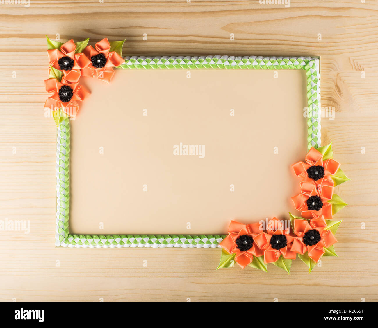 Photo frame with decorative flowers on wooden background Stock Photo