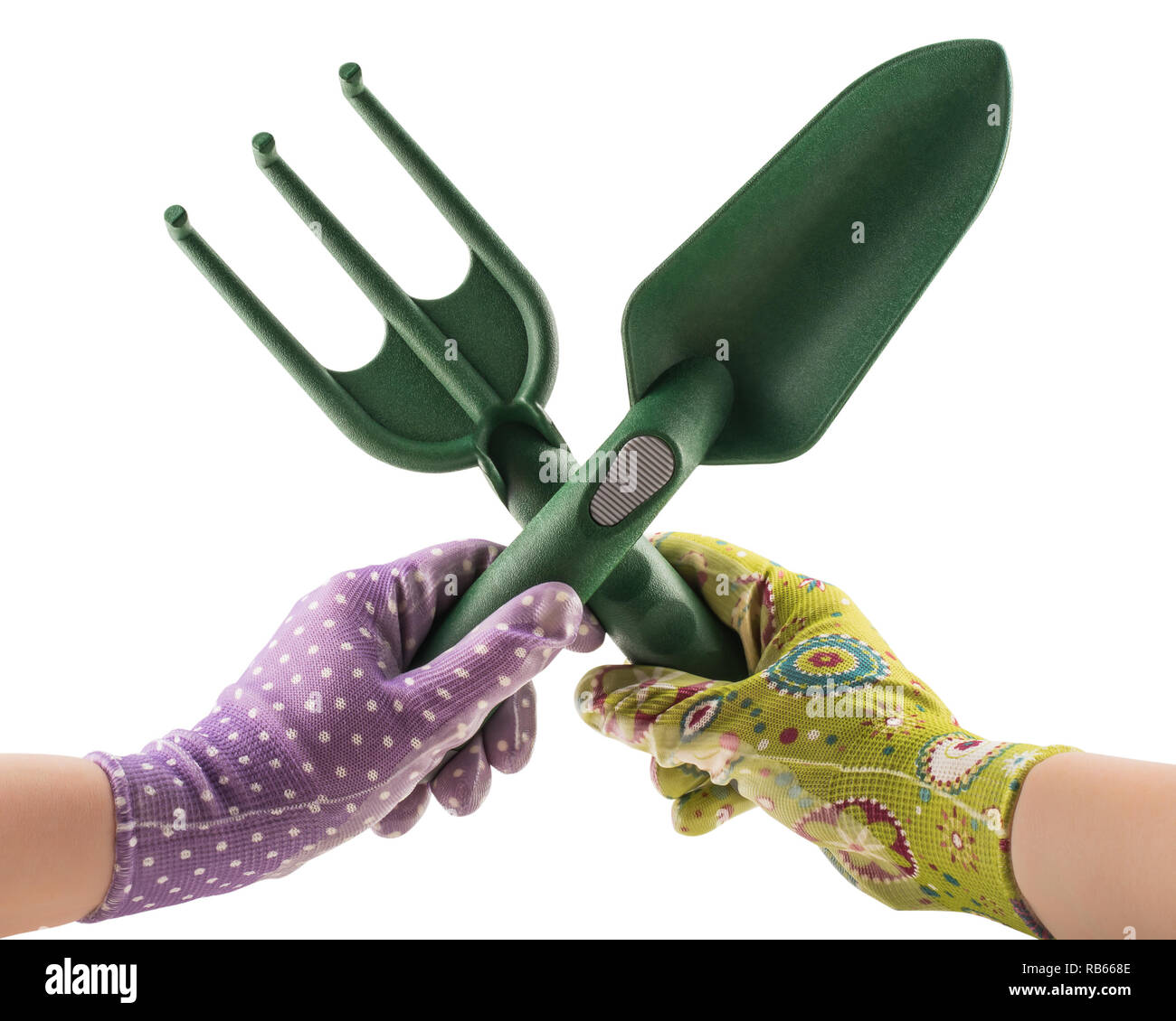 Crossed garden tools in gloved hands isolated on white background Stock Photo
