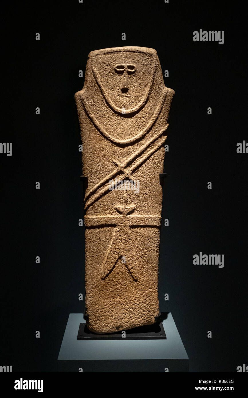 Funerary stele with male figure ( 4000-3000 BCE) displayed at Louvre Abu Dhabi. Stock Photo