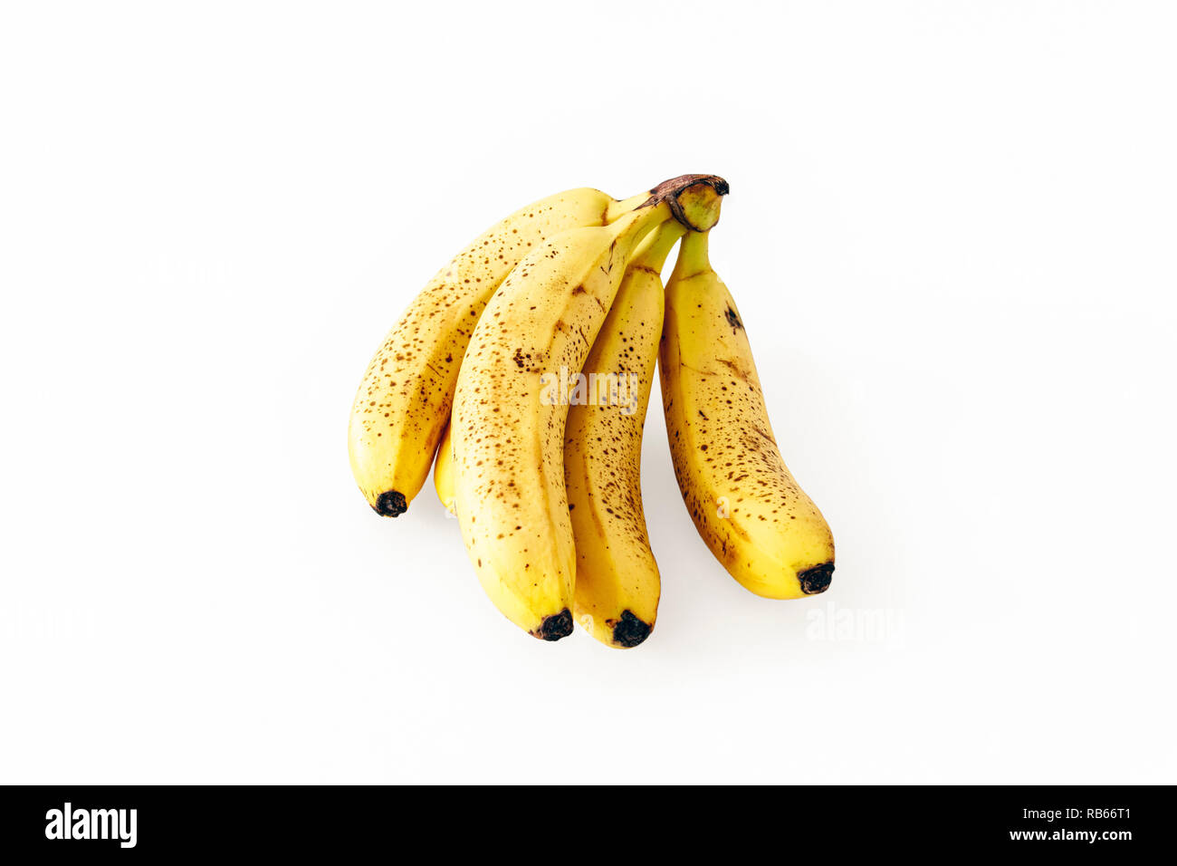 A bunch of five slightly overripe bananas isolated on a white background Stock Photo