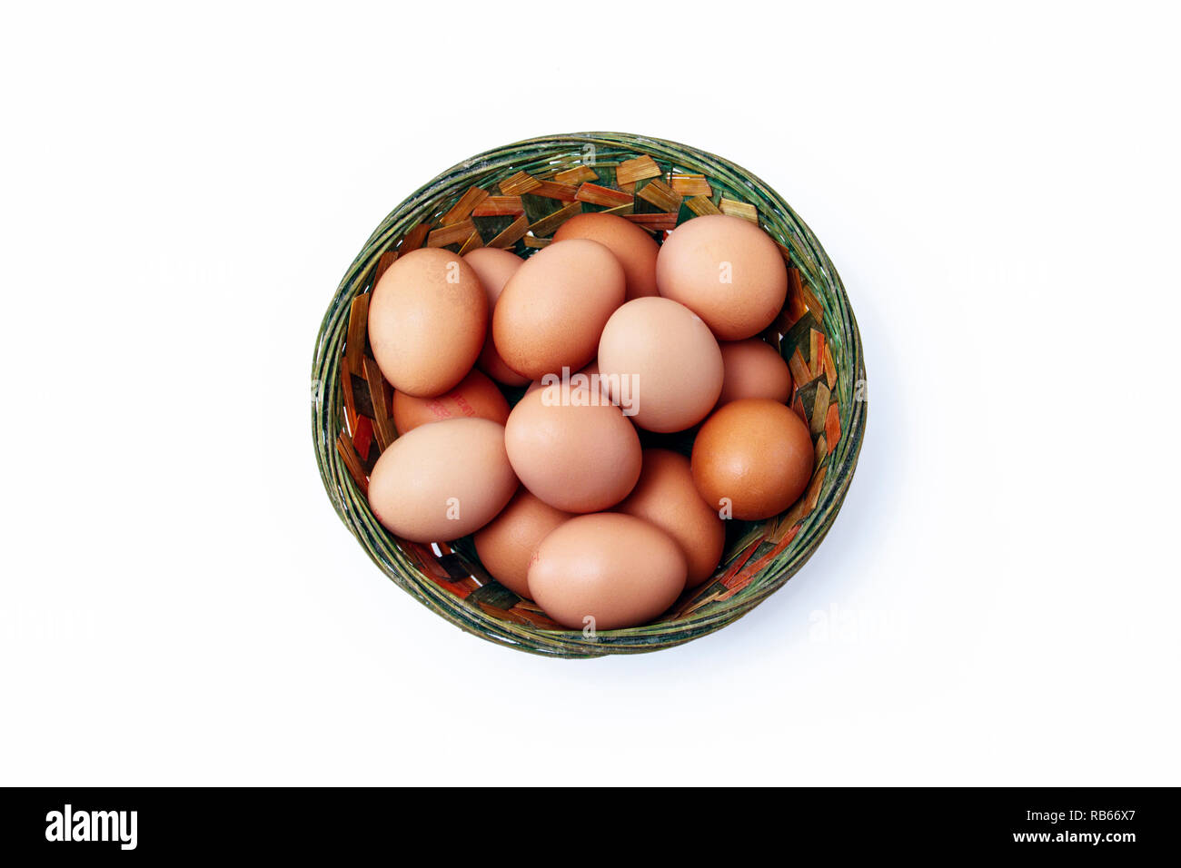 Large brown free-range eggs in a coloured rustic wicker basket Stock Photo