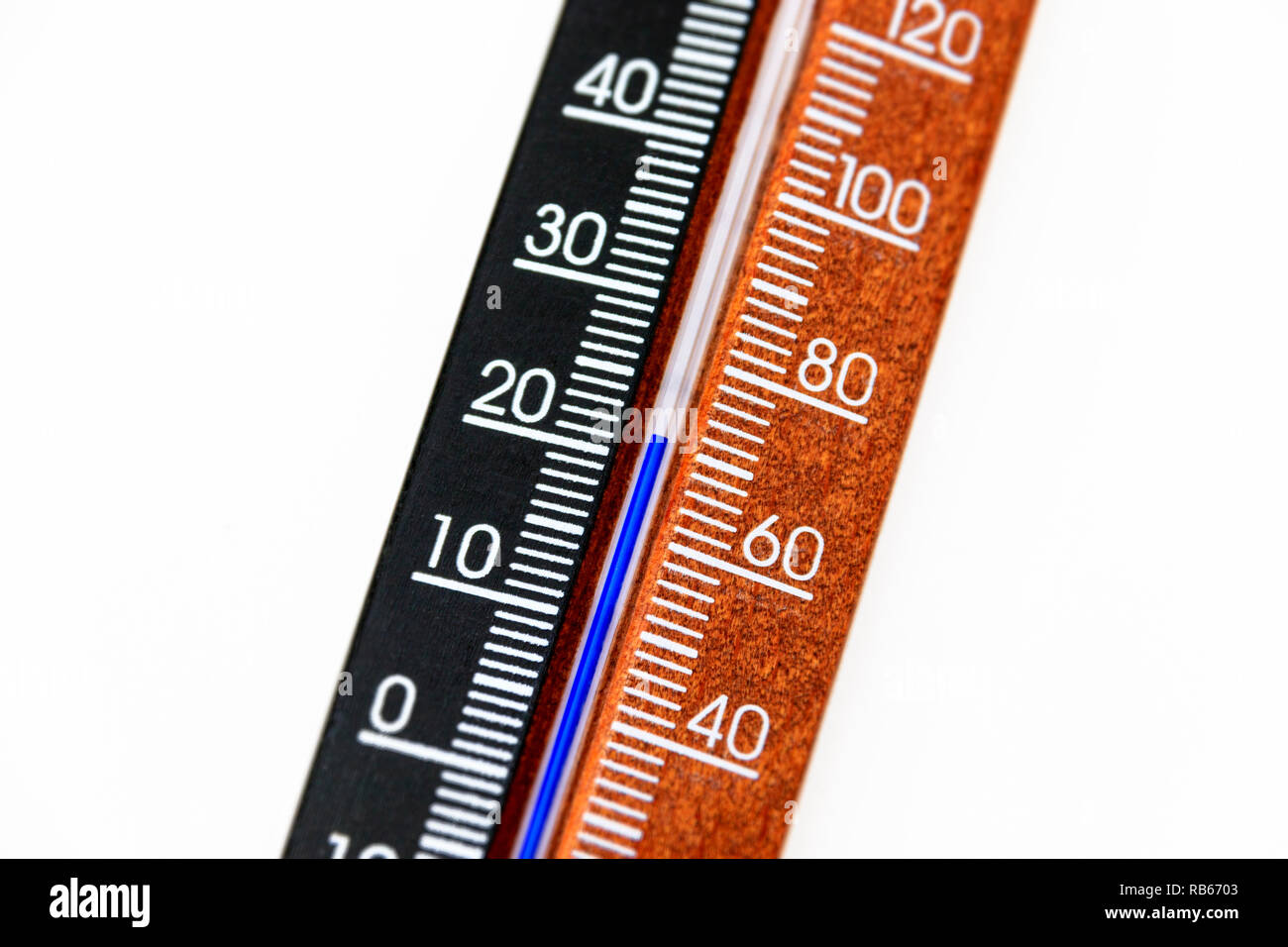 Close-up of a standard wooden room thermometer, marked in degrees Celcius and Fahrenheit, showing a temperature of 22ºC/70ºF Stock Photo