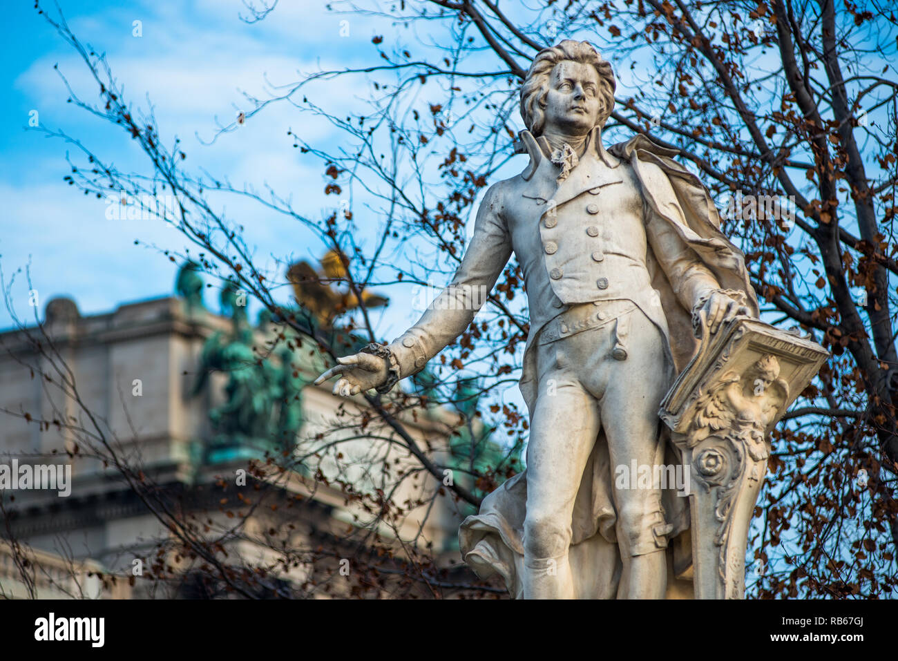 Mozart statue at Neue Burg building part of the Hofburg palace complex seen from Burggarten. Vienna, Austria. Stock Photo
