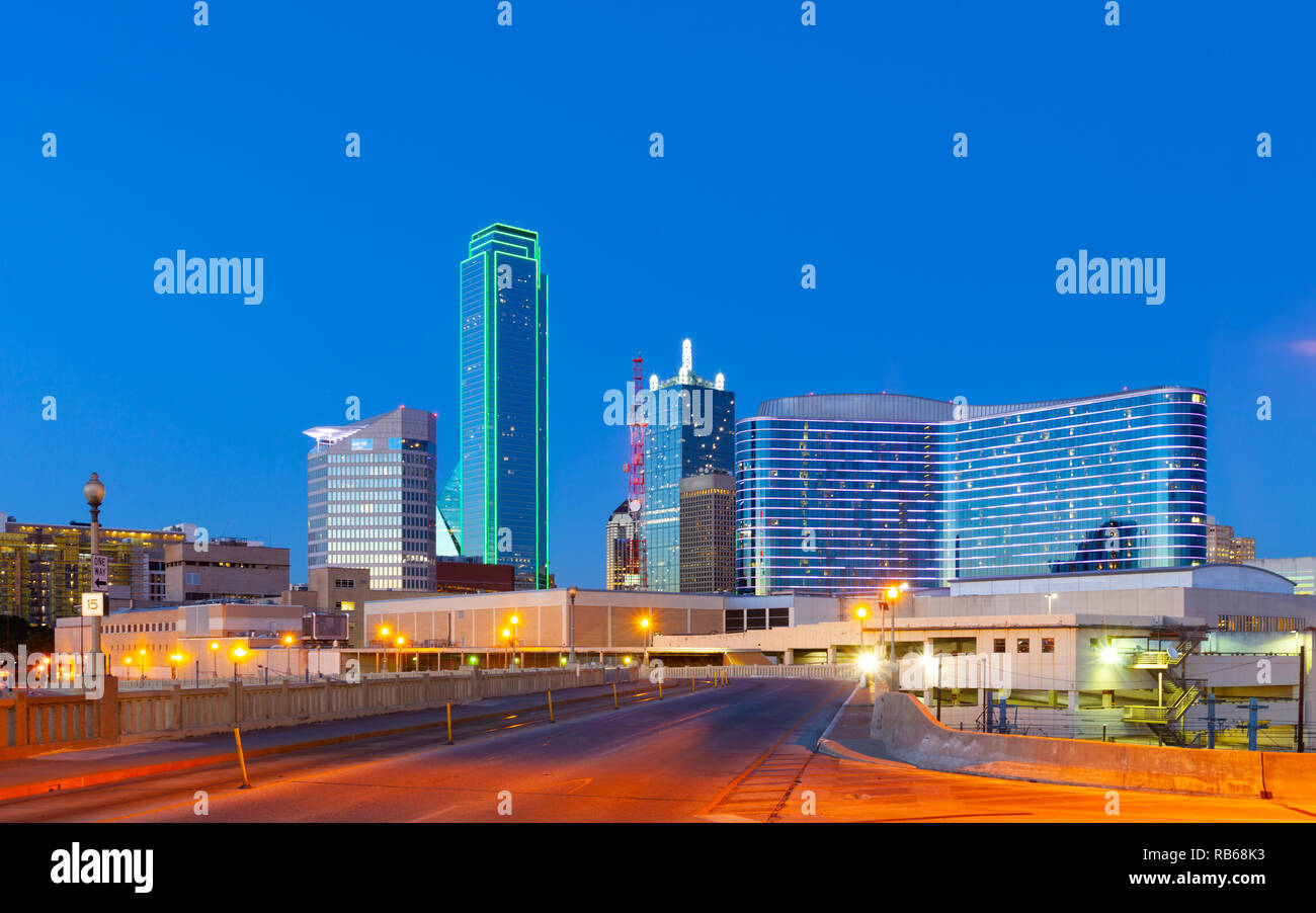 Downtown Dallas skyline at night with illuminated glass buildings seen from Houston Street Stock Photo