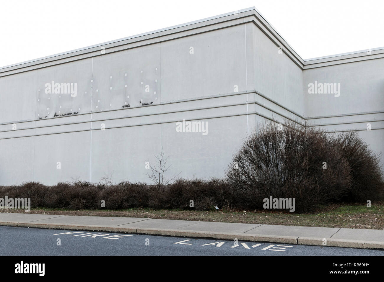 The outline of a logo sign at a closed Sears retail store in Selinsgrove, Pennsylvania, on December 30, 2018. Stock Photo