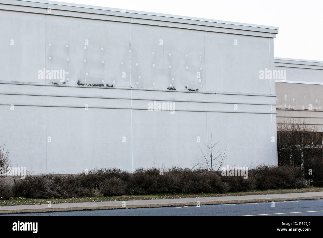 The outline of a logo sign at a closed Sears retail store in Selinsgrove, Pennsylvania, on December 30, 2018. Stock Photo