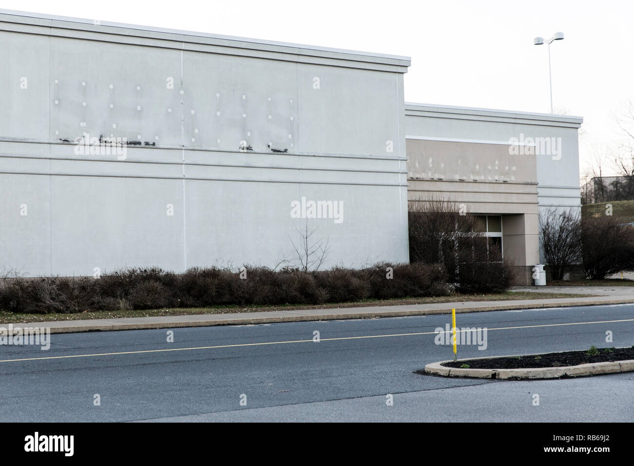 The outline of a logo sign at a closed Sears retail store in Selinsgrove, Pennsylvania, on December 30, 2018. Stock Photo