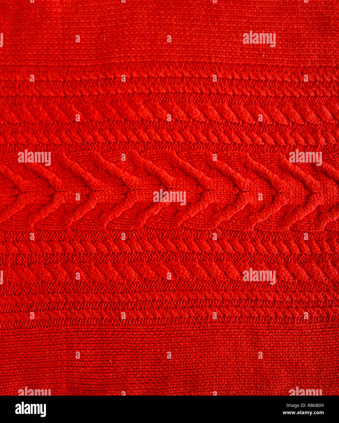 Red Wool Pattern Red Knitted pattern wool sweater texture close up. Handmade red ...