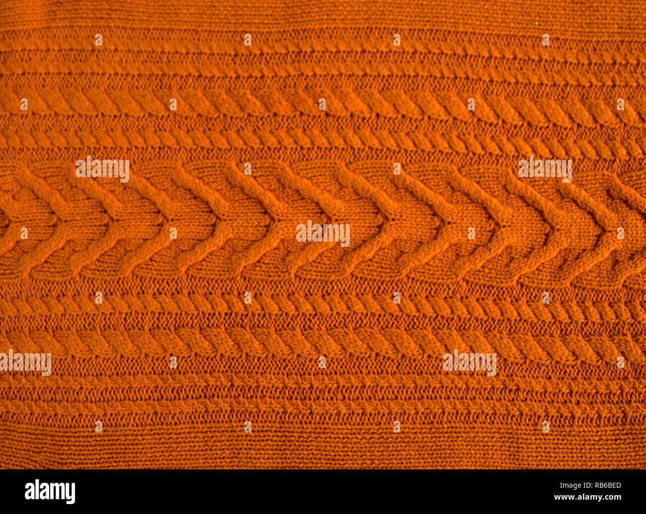 Orange Brown Terracotta Knitted pattern wool sweater texture close up. Handmade orange brown knitting wool texture background Stock Photo