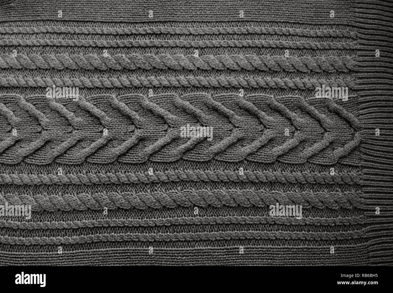 Grey Black Knitted pattern wool sweater texture close up. Handmade grey knitting wool texture background Stock Photo