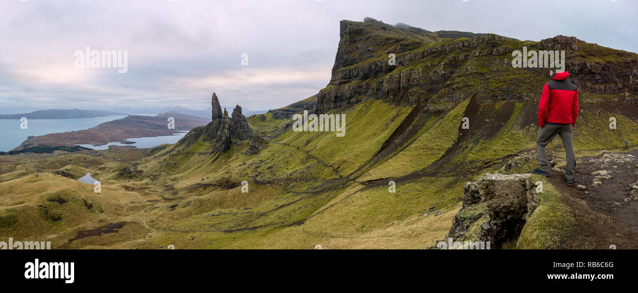 Hiker in panorama of Rugged volcanic landscape at Old Man of Storr, Isle of Skye, Scotland Stock Photo