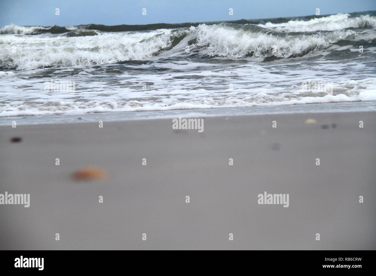 Waves breaking on sandy shore hi-res stock photography and images - Alamy