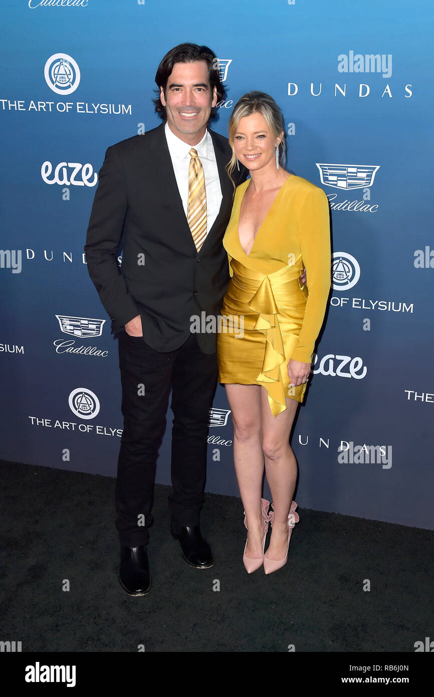 Carter Oosterhouse and his wife Amy Smart attending The Art of Elysium ...