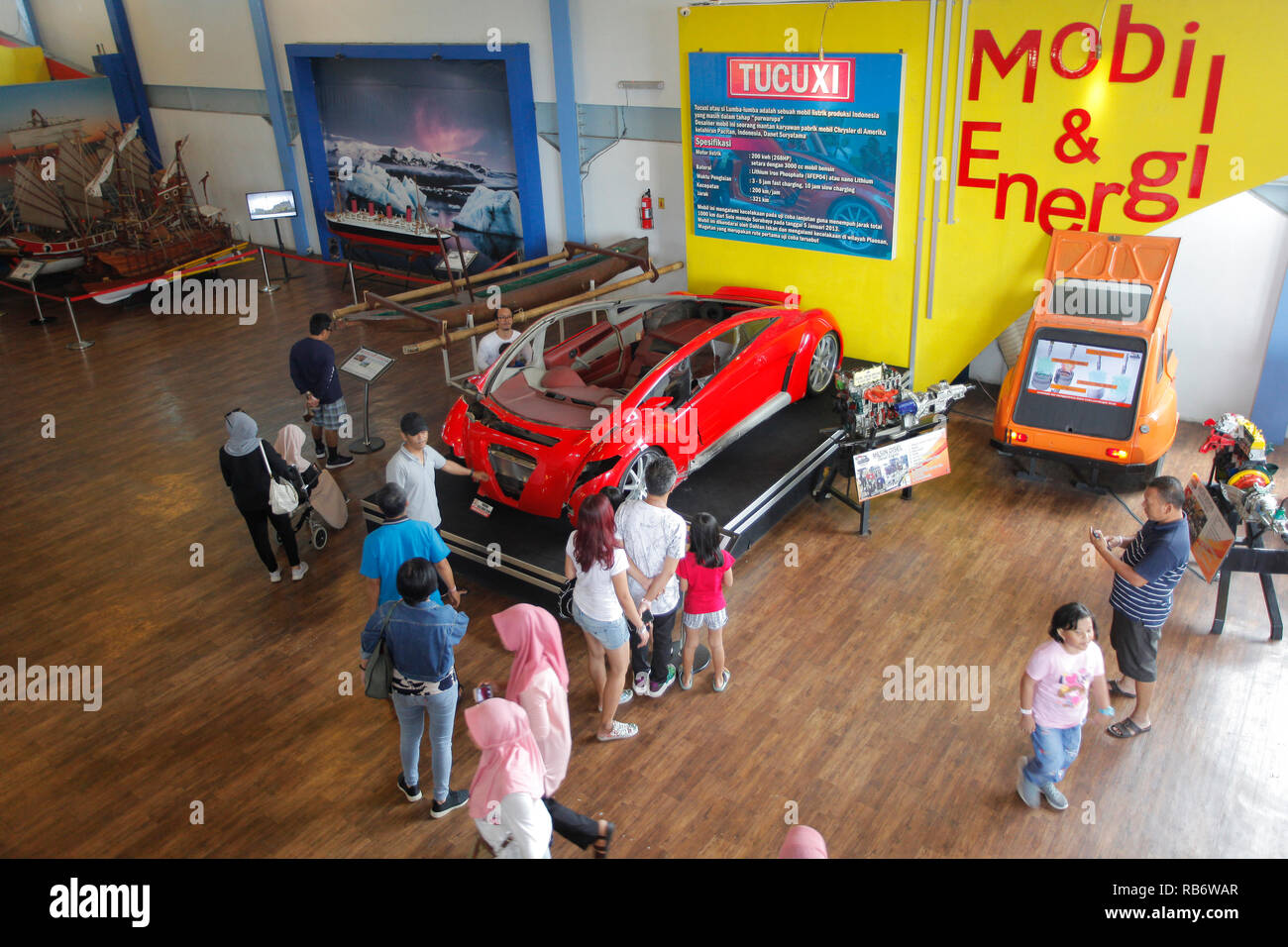 A number of visitors seen observing the Tucuxi electric car which was damaged by crashing several years ago at the Angkut Museum (Museum of Transportation). This museum has thousands of collections of vehicles from various . Stock Photo