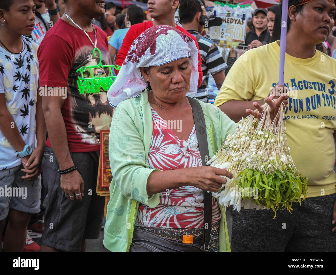 A vendor seen selling sampaguita at Quiapo church during the Feast of Black Nazarene preparation. Catholic devotees were seen flocking to Quiapo Church for the First Sunday mass of the year 2019 and also the preparation for the Feast of Black Nazarene on January 9. Stock Photo