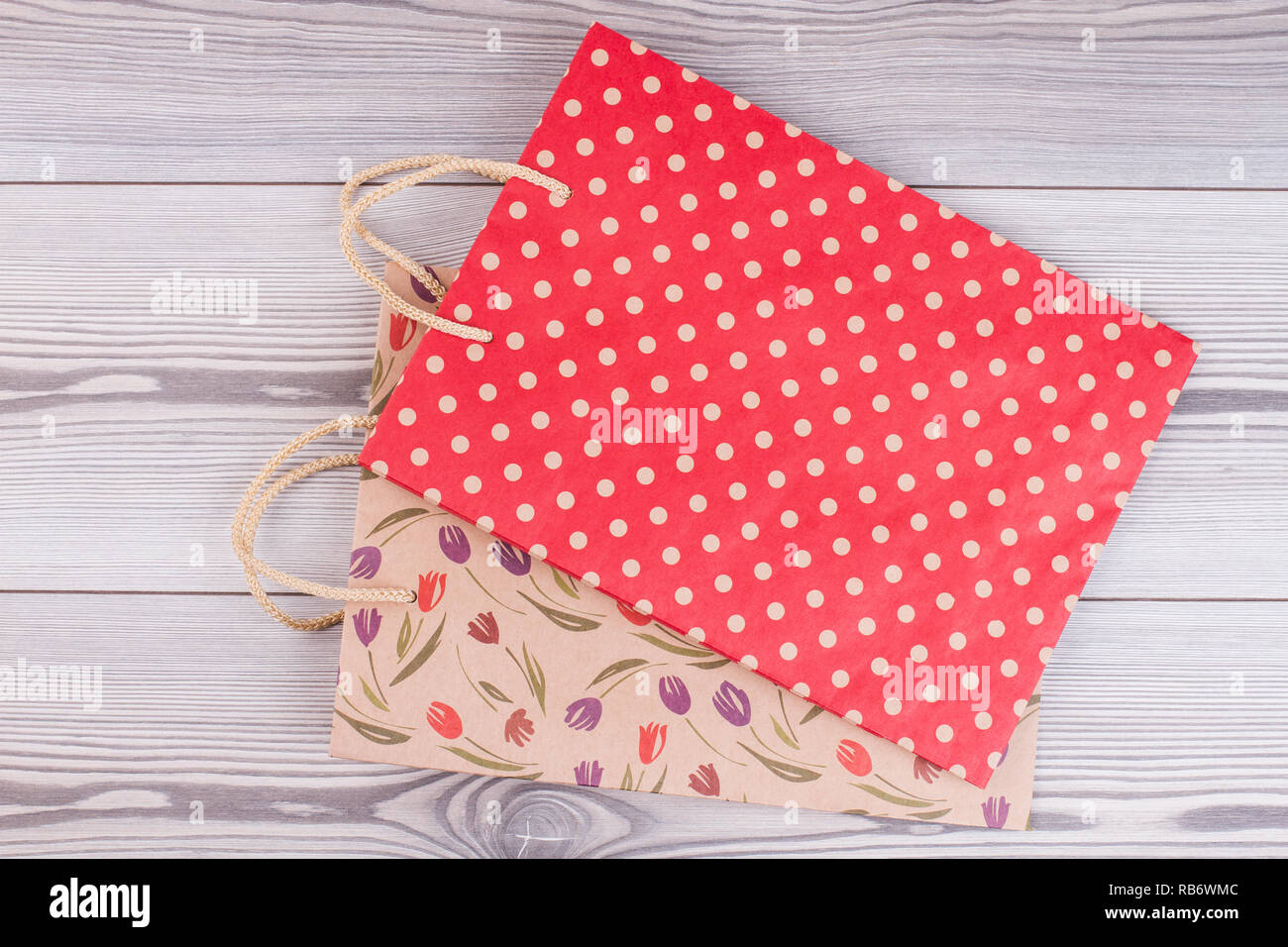 Download Printed Shopping Bags On Wooden Background Paper Carry Bags With Printing And Rope Handles Stock Photo Alamy Yellowimages Mockups