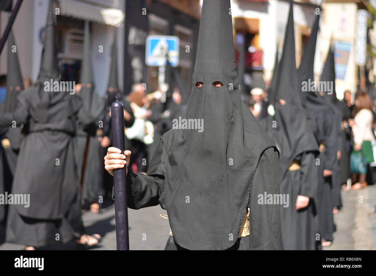 Hooded in black in a procession Stock Photo