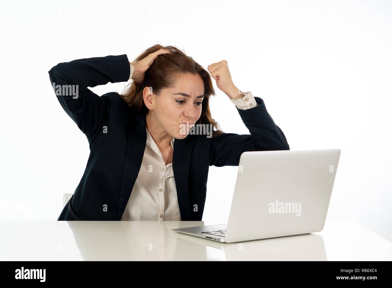 Young beautiful business woman suffering stress working at office computer desk feeling frustrated and tired looking overworked overwhelmed In busines Stock Photo