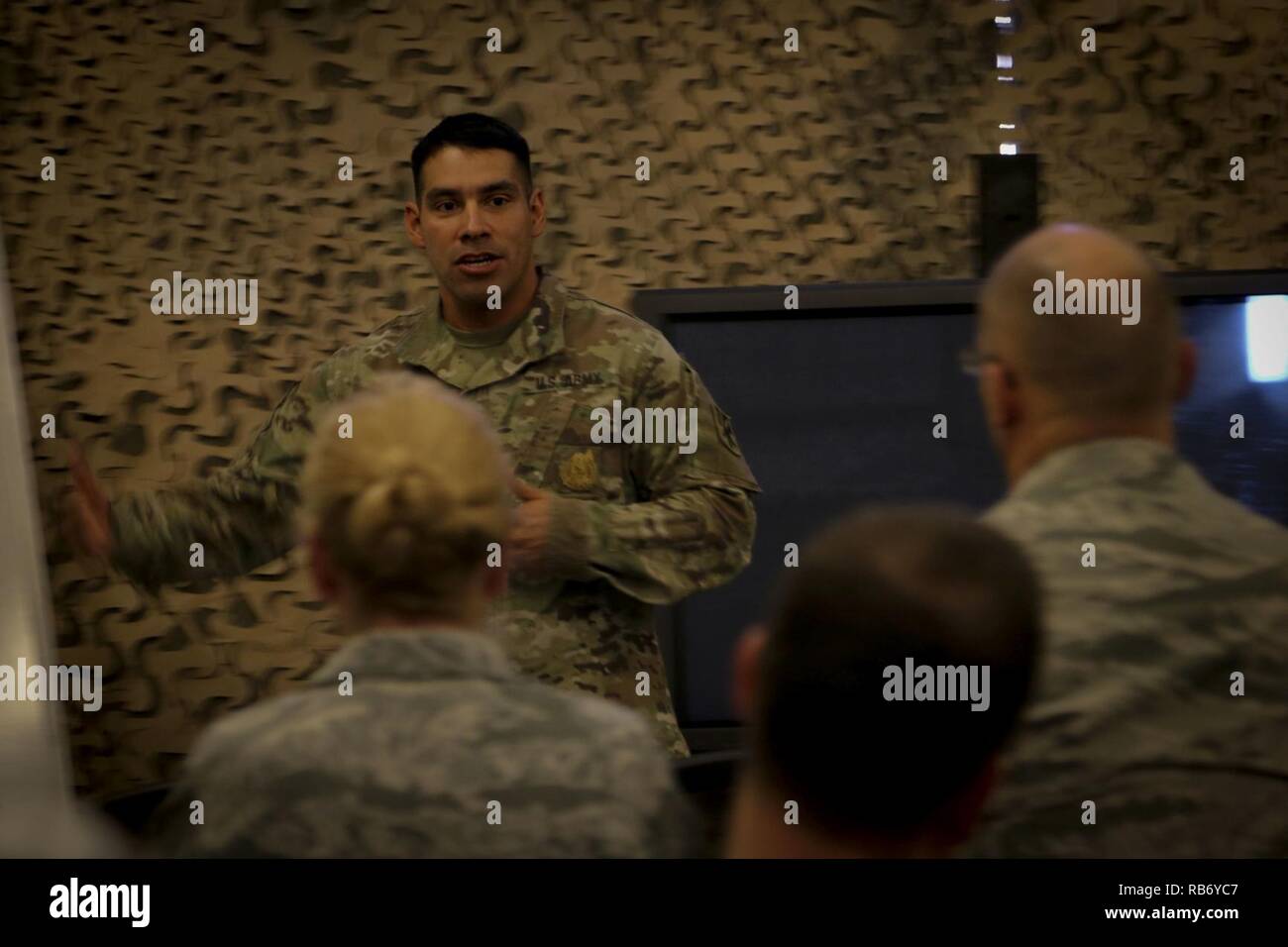 1st Sgt. Thomas Barrios, first sergeant of Battery B, 1st Battalion, 43rd Air Defense Artillery Regiment, 69th Air Defense Artillery “Top Notch” Brigade, talks about the Army’s air defense history during the Patriot Open House, Dec. 2 in U.S. Army Central’s area of responsibility. The group watched a video of the evolution of Patriot systems during Operation Desert Storm up to the modern day. Stock Photo