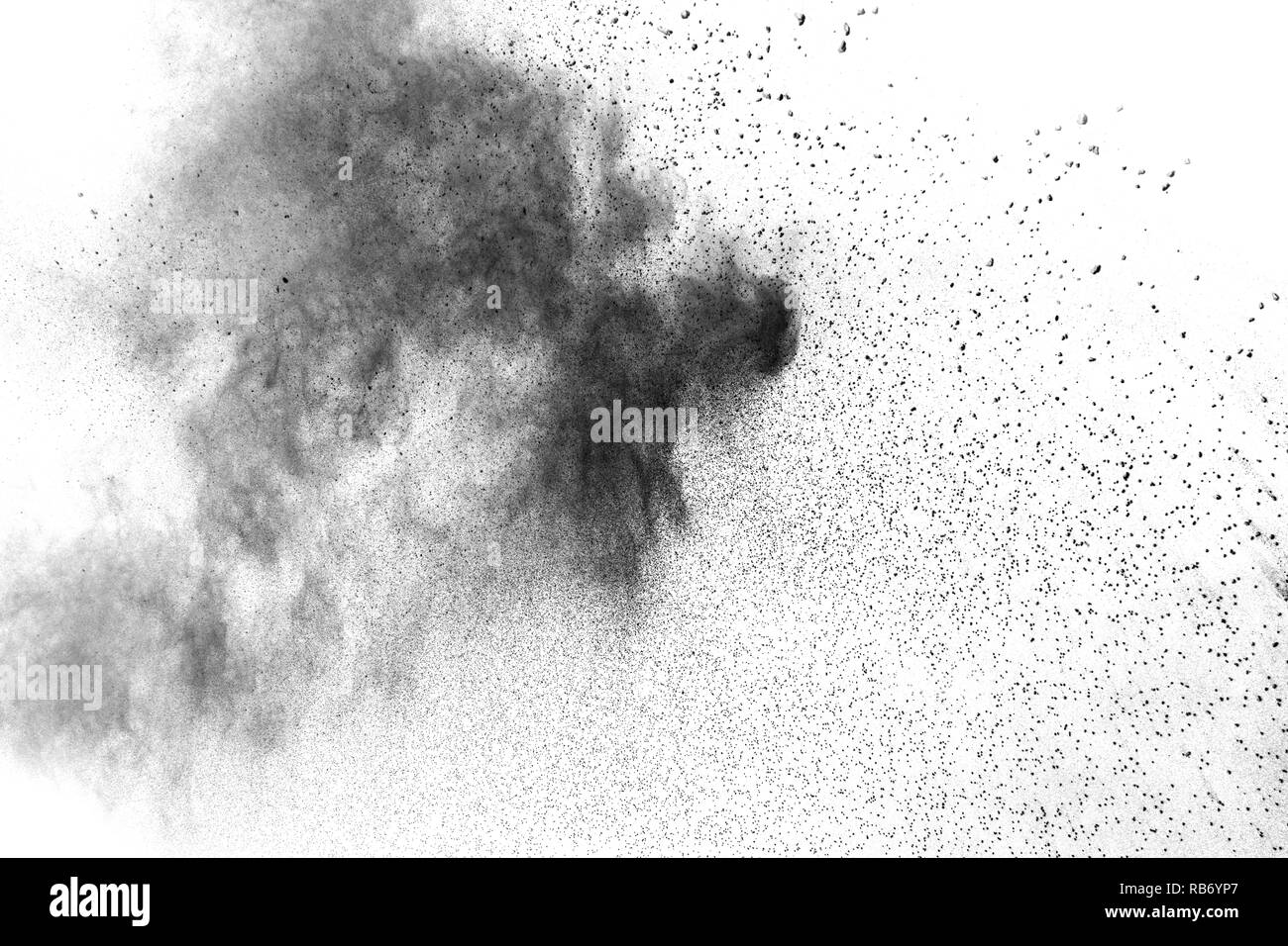 Black powder explosion against white background. Charcoal dust particle