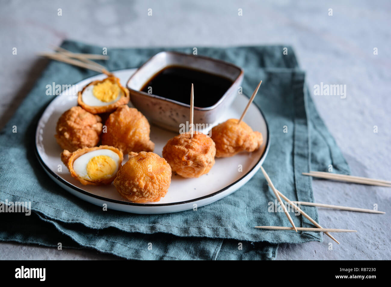 Kwek Kwek - traditional deep fried quail eggs coated with batter served with soya sauce and vinegar dip Stock Photo