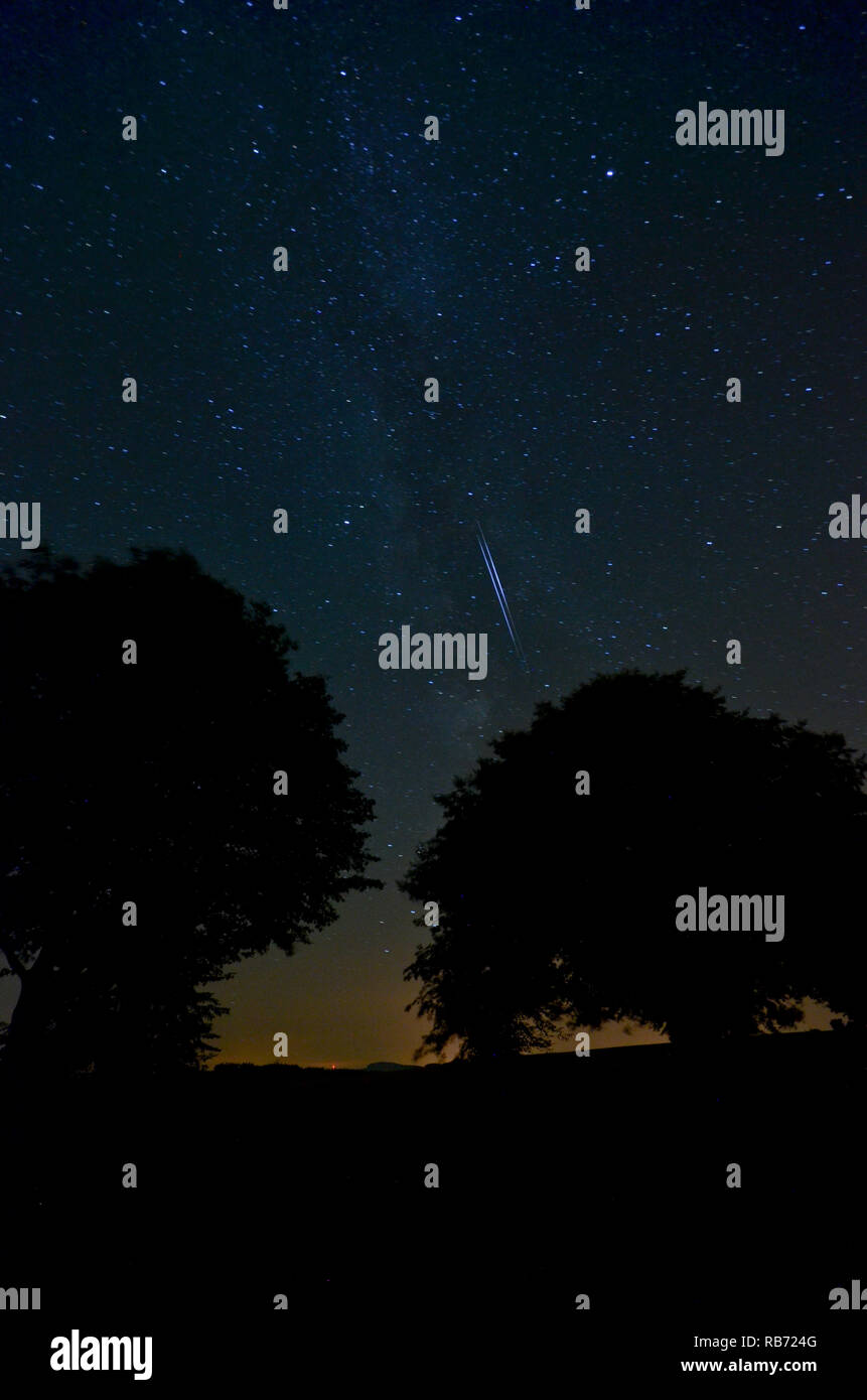 Night sky with iridium flare Stock Photo