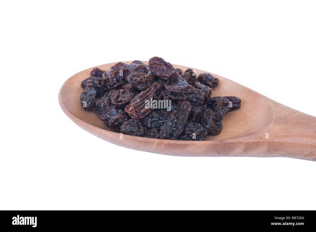 Raisins (Sultanas) in spoon wood isolated on white Stock Photo