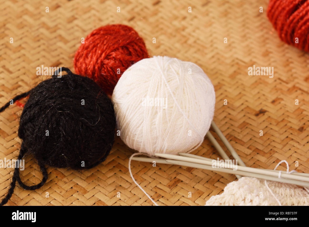 black yarn ball with hook for crocheting on brown background Stock Photos