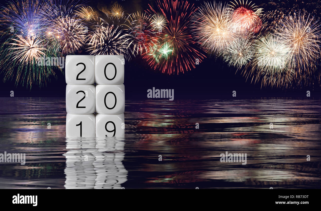 Composite of fireworks and calendar for 2020 New Year holiday background Stock Photo