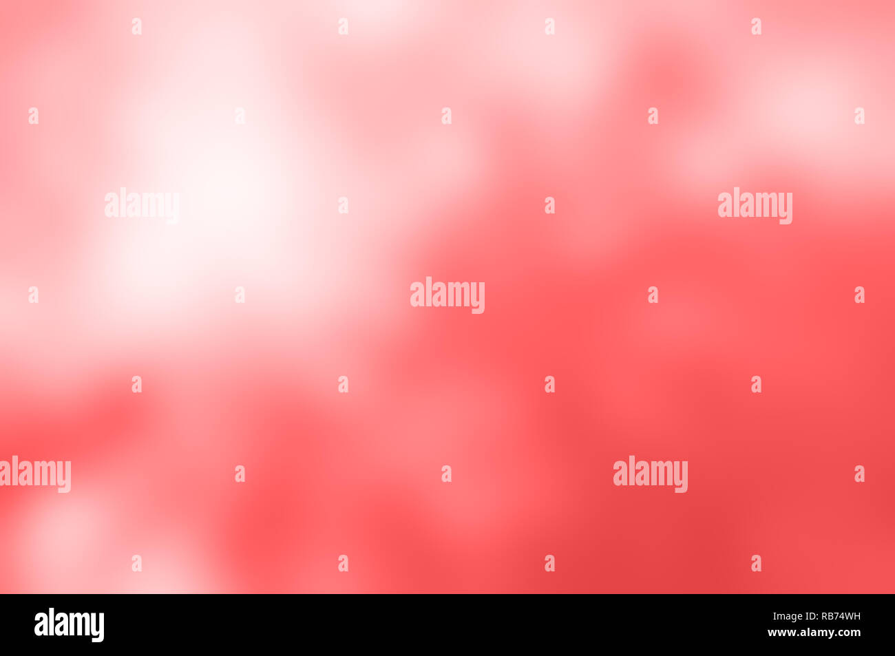Soft background blur of coral pink, dappled with white light. Stock Photo