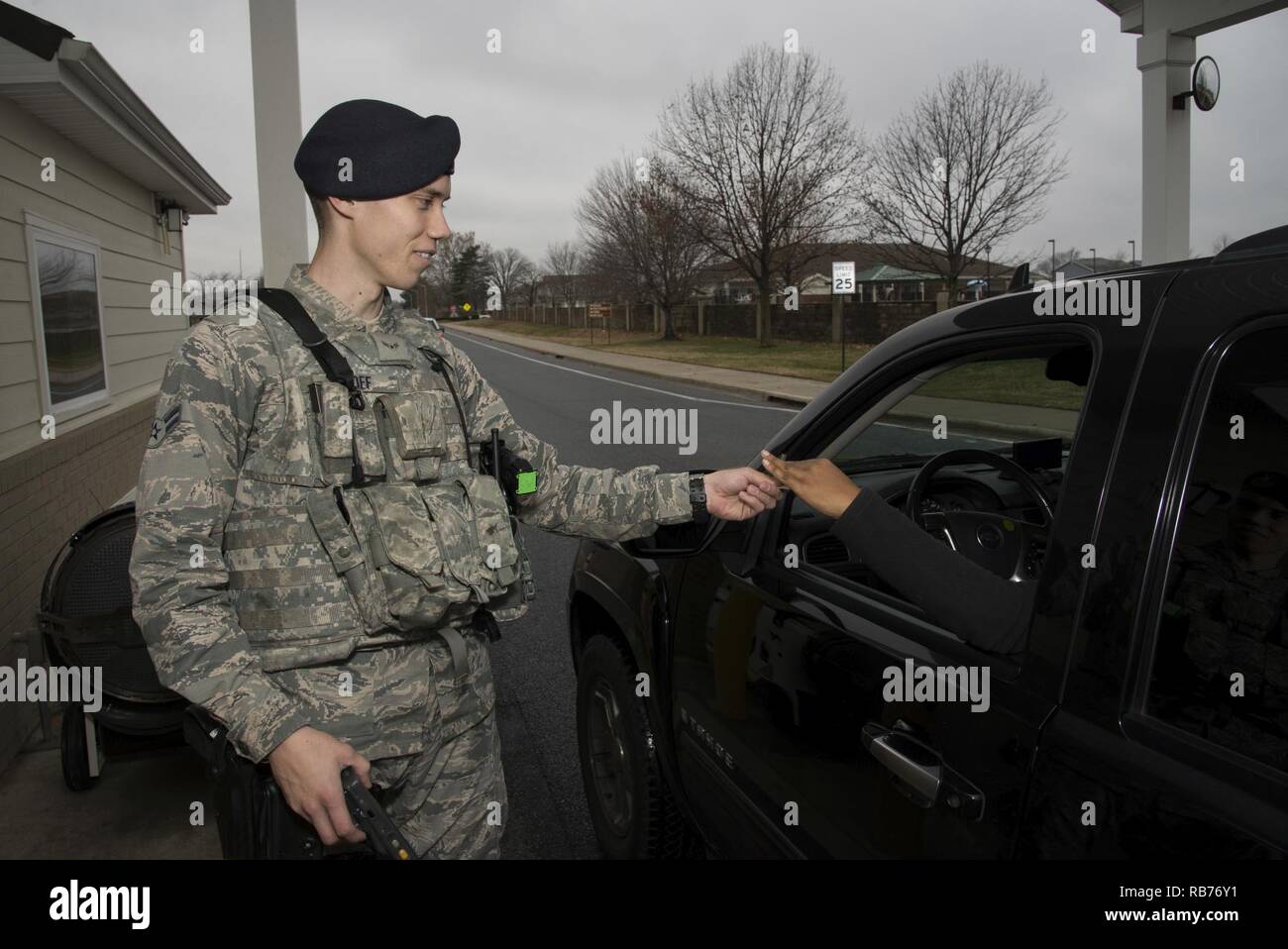 Airman 1st Class Jake Goff, 436th Security Forces Squadron defender, checks  an ID card Dec. 12, 2016, at the base housing gate on Dover Air Force Base,  Del. Defenders ensure year-round security