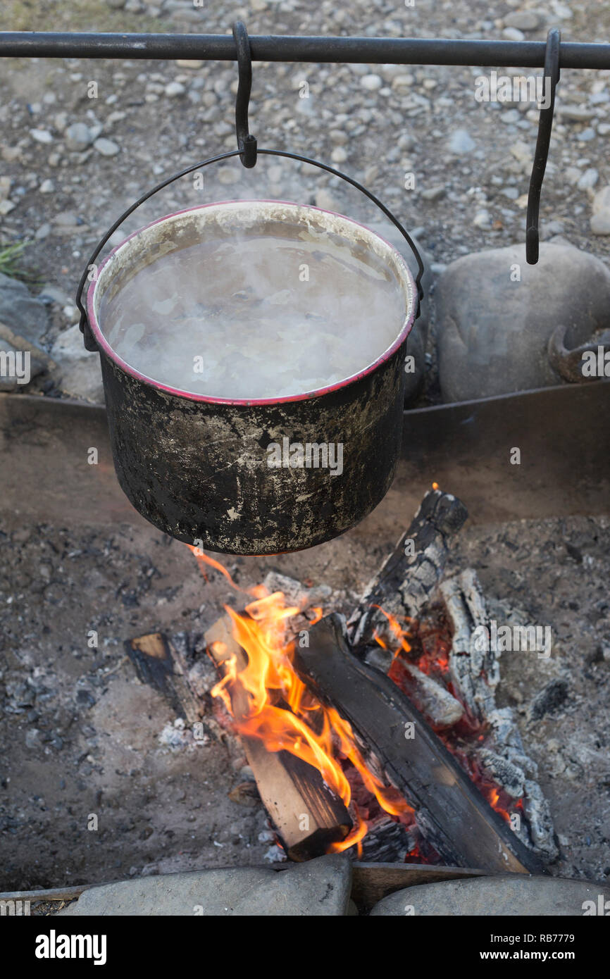 Water heating in pot over campfire at Bar U Ranch National Historic Site roundup camp Stock Photo